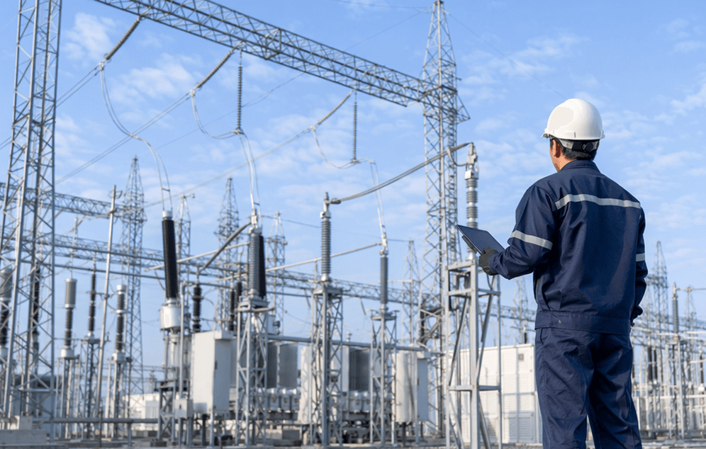 A utility lineworker inspecting electrical infrastructure in the field